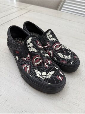 Vans Black Slip-On Sneakers with Cream Skull & Red Mouth Graphics